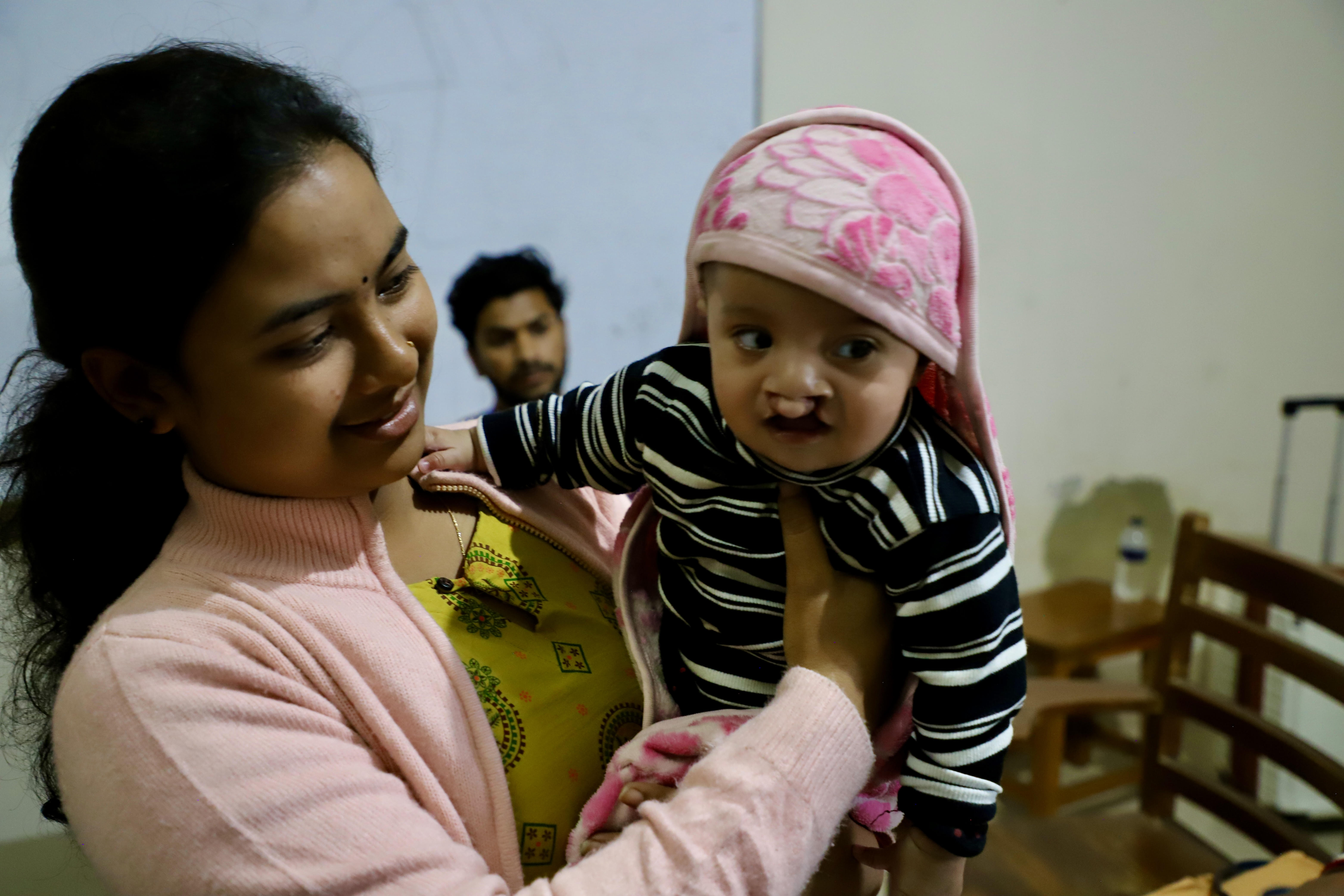 Mother holding child before surgery